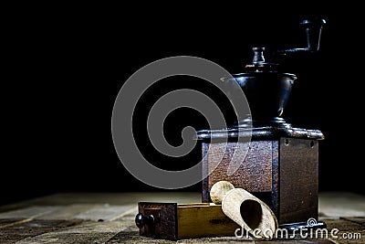 Old stylish grinder for grinding tasty coffee on an old wooden t Stock Photo