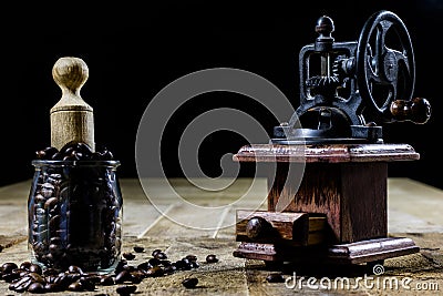 Old stylish grinder for grinding tasty coffee on an old wooden t Stock Photo