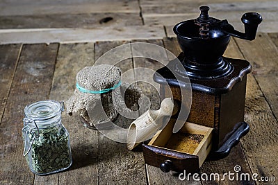 Old stylish grinder for grinding tasty coffee on an old wooden t Stock Photo