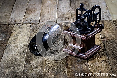 Old stylish grinder for grinding tasty coffee on an old wooden t Stock Photo