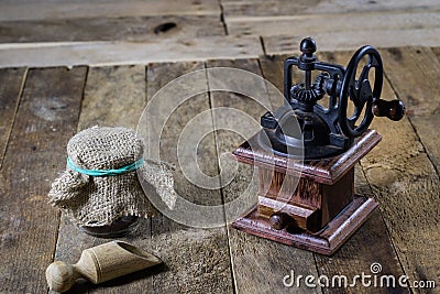 Old stylish grinder for grinding tasty coffee on an old wooden t Stock Photo