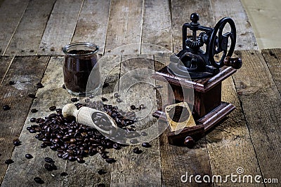 Old stylish grinder for grinding tasty coffee on an old wooden t Stock Photo