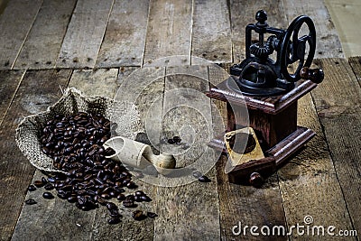 Old stylish grinder for grinding tasty coffee on an old wooden t Stock Photo