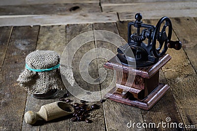 Old stylish grinder for grinding tasty coffee on an old wooden t Stock Photo