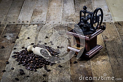 Old stylish grinder for grinding tasty coffee on an old wooden t Stock Photo