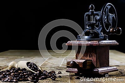 Old stylish grinder for grinding tasty coffee on an old wooden t Stock Photo