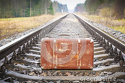 Old suitcase on the railway Stock Photo