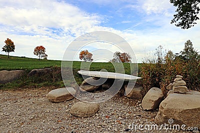 An old surfboard lies in autumn on a boisterous lake on the dry shore Stock Photo