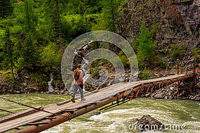 Old suspension bridge over a mountain river. Chuya, Altai Stock Photo