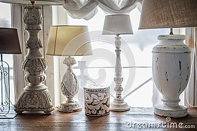 Old table lamp standing on the table, carved legs, lots of lamps, a vintage Stock Photo