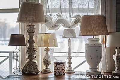 Old table lamp standing on the table, carved legs, lots of lamps, a vintage Stock Photo