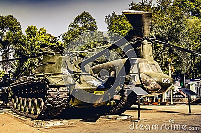 Old tank and Chinook helicopter on display in the War remnants museum in Saigon. Both fought in the Vietnam war. (Ho Chi Minh City Editorial Stock Photo