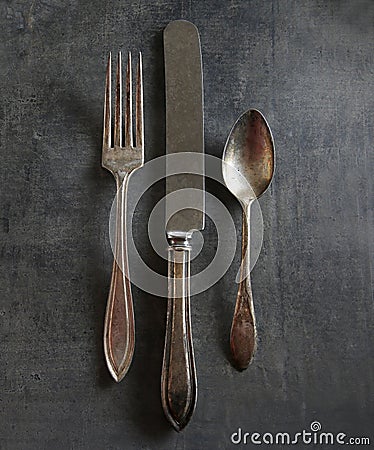 Old tarnished fork,knife and spoon Stock Photo