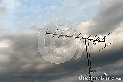 Old television antenna or TV antenna on a background cloudy skyDark powerful storm clouds before rain against. concept of a Stock Photo