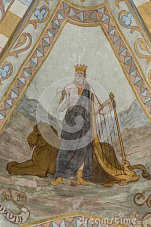 The old testament king david stands in front of a lion and holds the harp, an ancient fresco Editorial Stock Photo