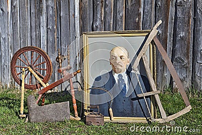 Old things near barn, portrait of Lenin, spinning wheel, handsaw Editorial Stock Photo