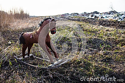 Old thrown away rocking horse Stock Photo