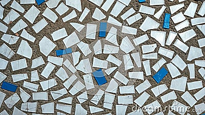 Old tiles in concrete, mosaic, broken ceramics in the building. Background of a house in the city. Stock Photo