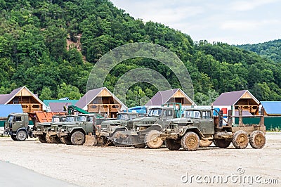 Old timber trucks in the mud Stock Photo