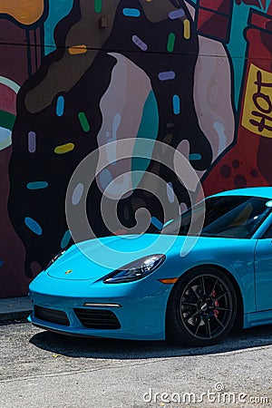 From old to new, Porsche sports cars parked near an art mural in a downtown art Miami district Editorial Stock Photo