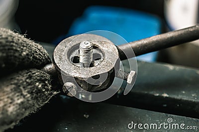 Old tools ,Mechanic using Taps and Dies tool Making Internal and External Threads nut at motorcycle garage .selective focus Stock Photo