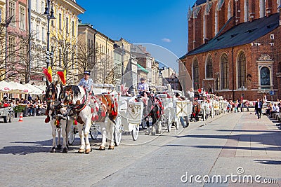 Old town market square of Krakow, Poland with horse carriages. Editorial Stock Photo