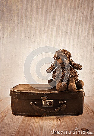 Old toy on a small road suitcase. Stock Photo