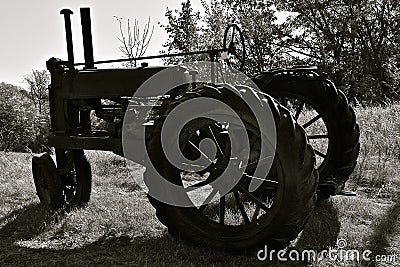 Old tractor silhouette brings back past farm memories Stock Photo