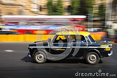 Old traditional black and yellow taxi in movement depicted with motion blur panning Editorial Stock Photo