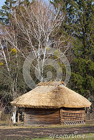 Old traditional Ukrainen barn or shack under blue sky Stock Photo