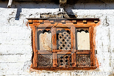 Old traditional wooden window a in small local village in Nepal, Himalaya Stock Photo