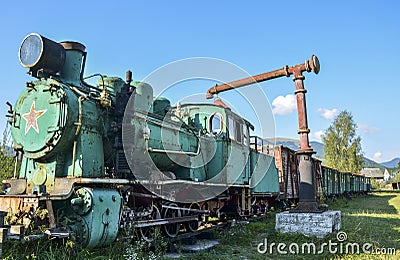 Old train locomotive green color on network of narrow-gauge railway in Carpathian village Kolochava, Ukraine Editorial Stock Photo