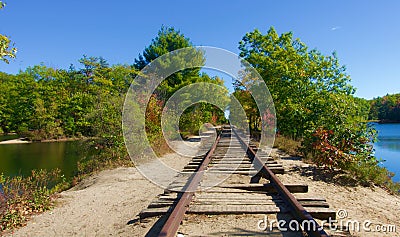 Abandoned railroad tracks running over a wilderness lake in Maine Stock Photo