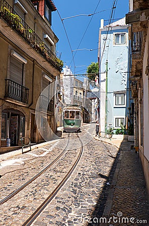 Old tram number 28 on the narrow street of Alfama. Lisbon. Portugal Editorial Stock Photo