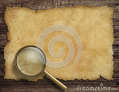 Old treasure map on wooden desk with magnifying Stock Photo