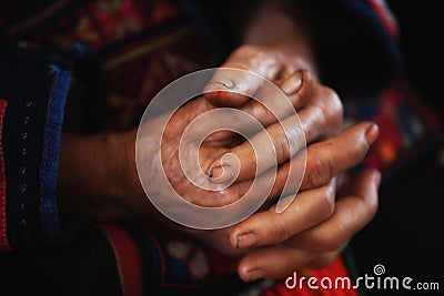 Old tribal woman with wrinkle hands clasped Stock Photo