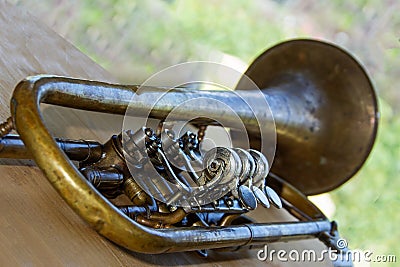 Old trumpet - wind musical instrument. Shallow depth of field. Background is blurred Stock Photo