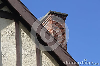 Old Tudor Style Wall and Roofline with Brick Chimney Stock Photo