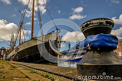Old tugboat moored at the quay of the former shipyard `Willemsoord` in the harbour of Den Helder, the Netherlands. Editorial Stock Photo