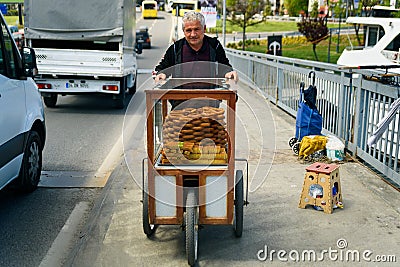 Old Turkish man selling traditional turkish bread in the street, street vendor smiling in Istanbul, 20 April 2023 Editorial Stock Photo