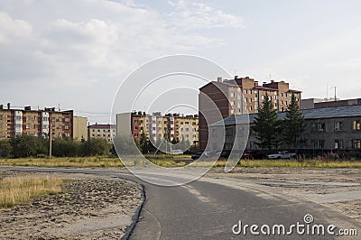 Old two-storeyed and modern many-storeyed building. Ð¡ontrast and opposite Stock Photo