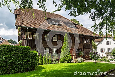 Old two-story wooden dwelling house with an attic and a tiled roof in Lucerne, Switzerland Stock Photo