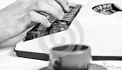 Old typewriter and authors hands. Male hands type story or report using white vintage typewriter equipment close up Stock Photo
