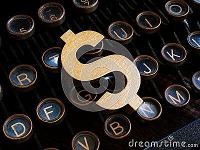 An old typewriter and a dollar sign as symbol of content monetization. Stock Photo