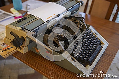 The old typewriter in vintage retro style on a wooden table. Caution - slightly shallow and possibly blurred depth of field Stock Photo