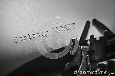Old typewriter with the written text Strictly SECRET. Stock Photo