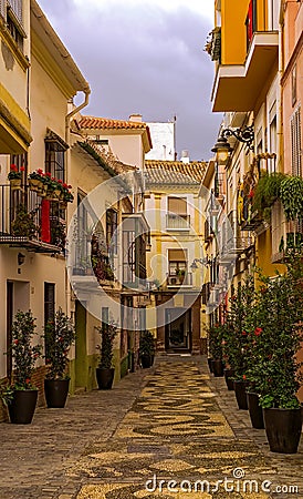 Old typical Andalucian street with flowers. Editorial Stock Photo