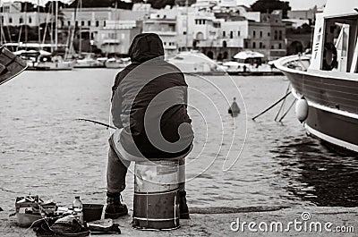 Old unemployed man fishing Stock Photo