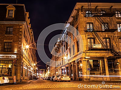 Old urban architecture of Montreal culture patrimony. Small street and historical buildings in the historic site of Old Port from Editorial Stock Photo