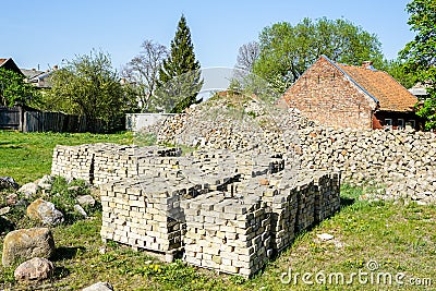 Old used bricks, stacked into cubes on pallets Stock Photo